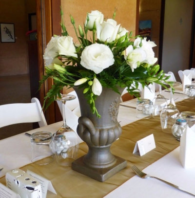 Floral arrangement in stone urn $POA