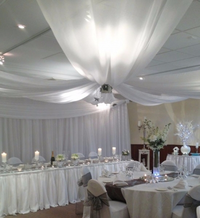Ceiling drapes with flower cage and crystal centrepiece